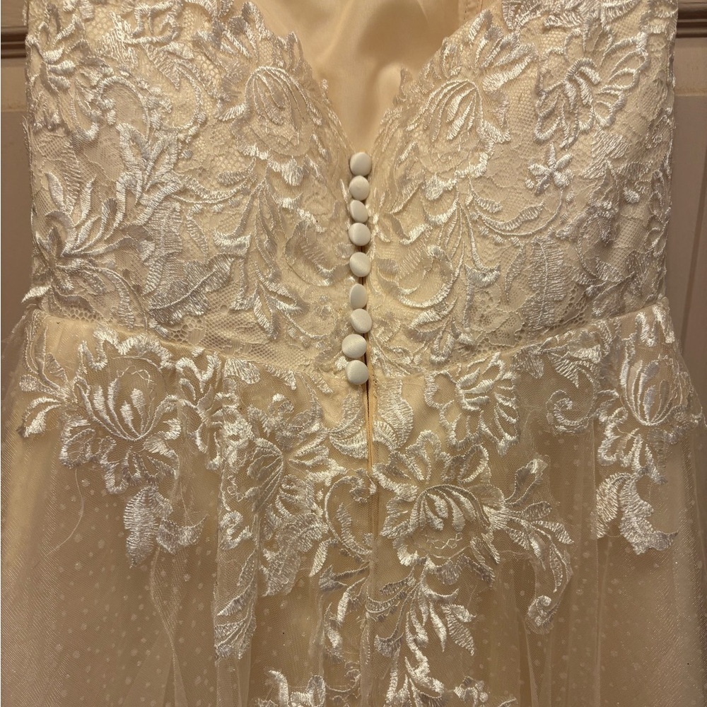 Size 8 never worn tea length wedding dress ivory colored